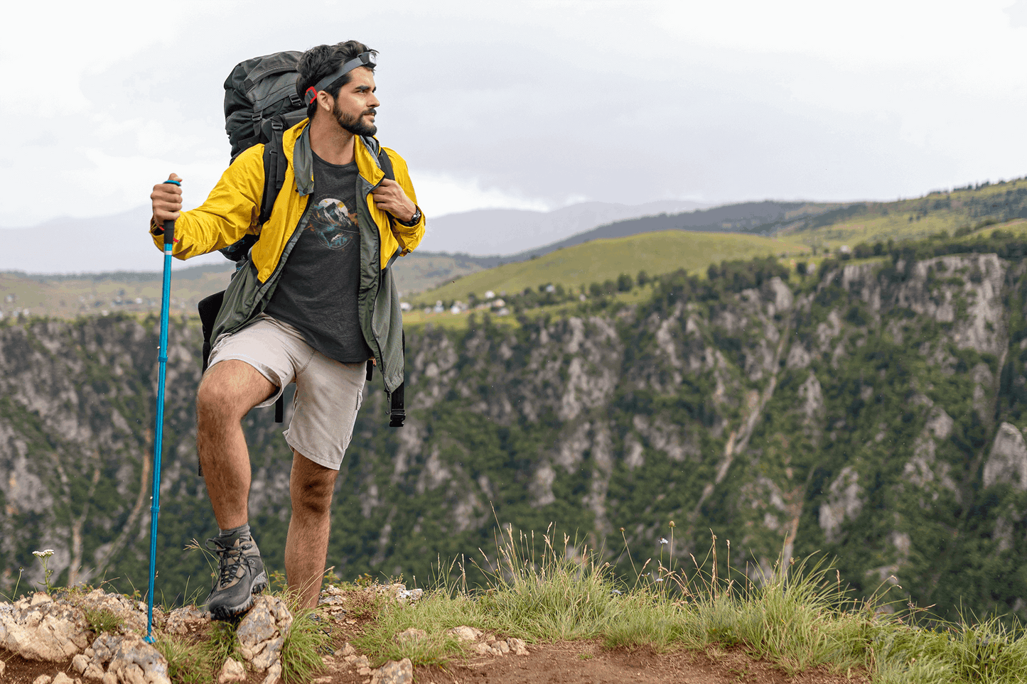 Man hiking in Wyld Peak Peak black organic tee on scenic American trail