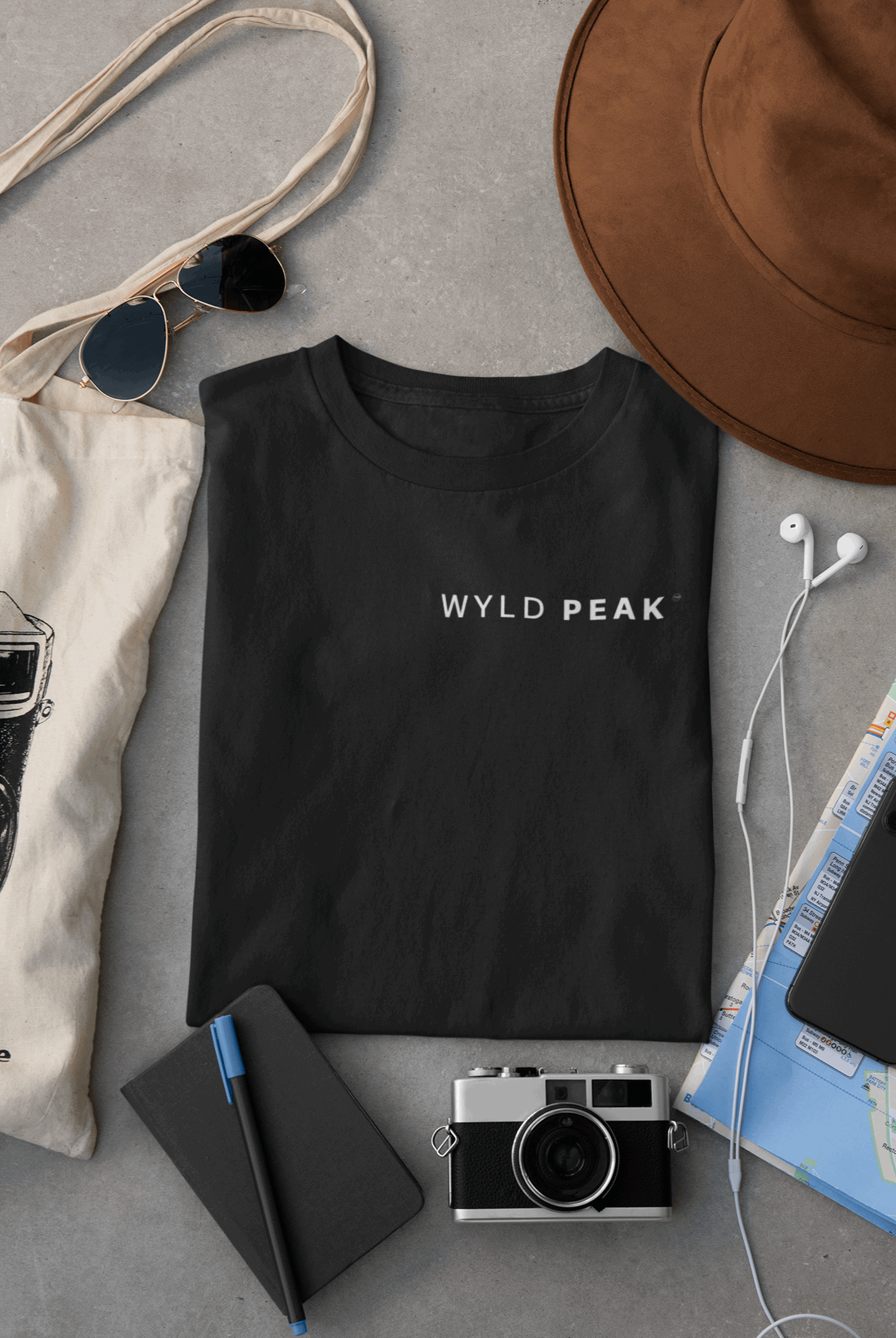 Wyld Peak men’s signature tee in black laid flat on desk.