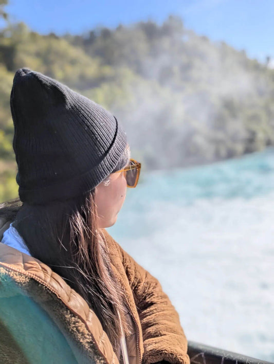 Ann in a Wyld Peak organic beanie overlooking the powerful turquoise waters of Huka Falls, New Zealand
