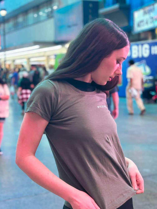 Marianne wearing a Wyld Peak tee while modeling on Fremont Street, Las Vegas – bold adventure style meets urban lights