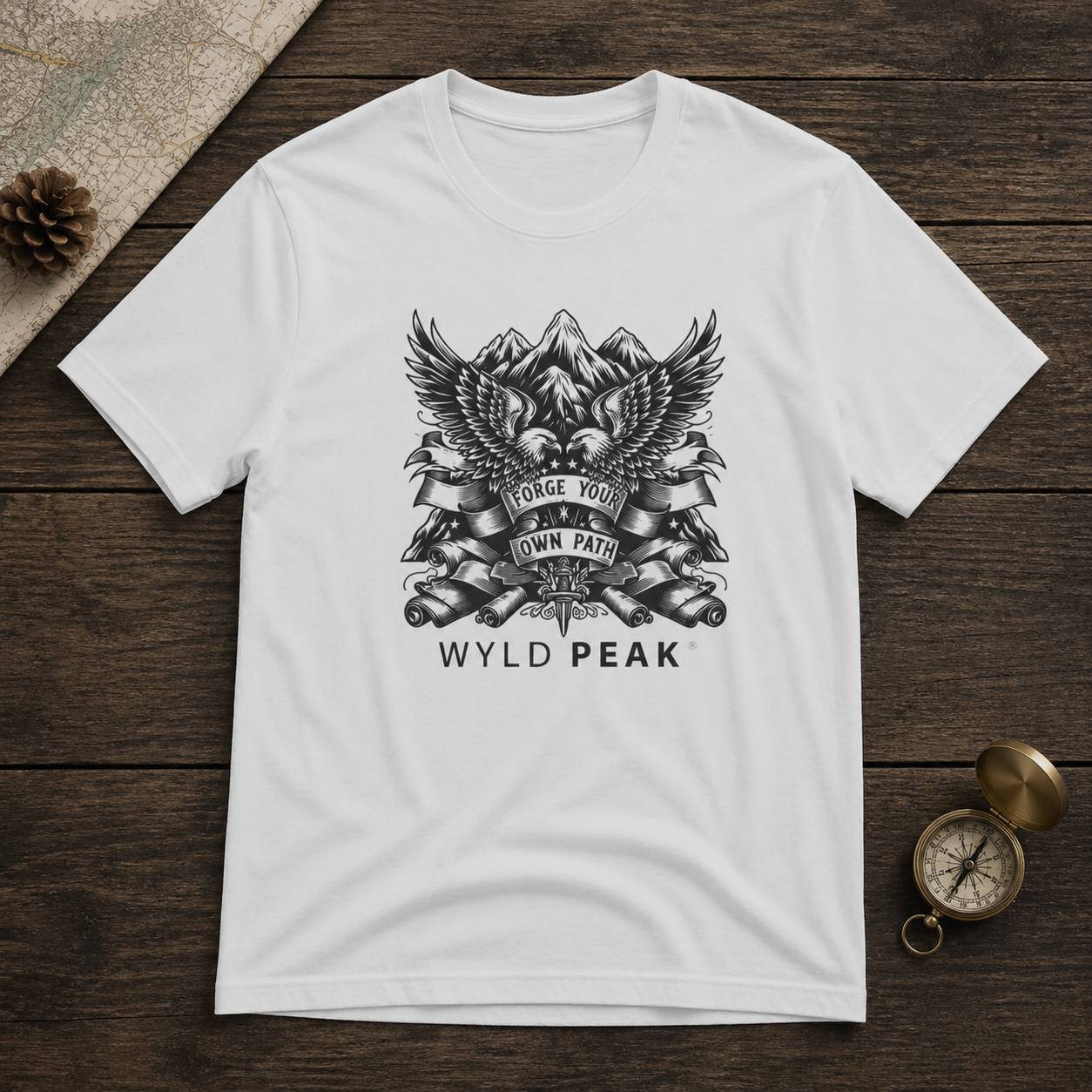 White t-shirt with black graphic design on a wooden surface