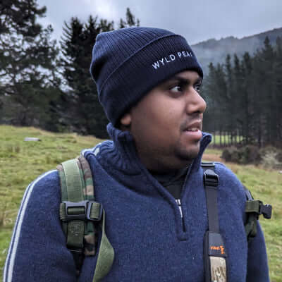 Face shot of Avi from Wyld Peak wearing a classic beanie.