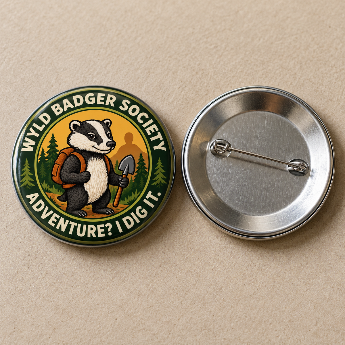 Two round pinback buttons on a beige textured background. The left button shows the front design with a cartoon badger holding a shovel and backpack, surrounded by the text 'WYLD BADGER SOCIETY' and 'ADVENTURE? I DIG IT.