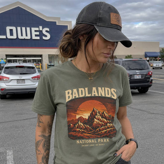 Person wearing a 'Badlands National Park' t-shirt in front of a Lowe's store.