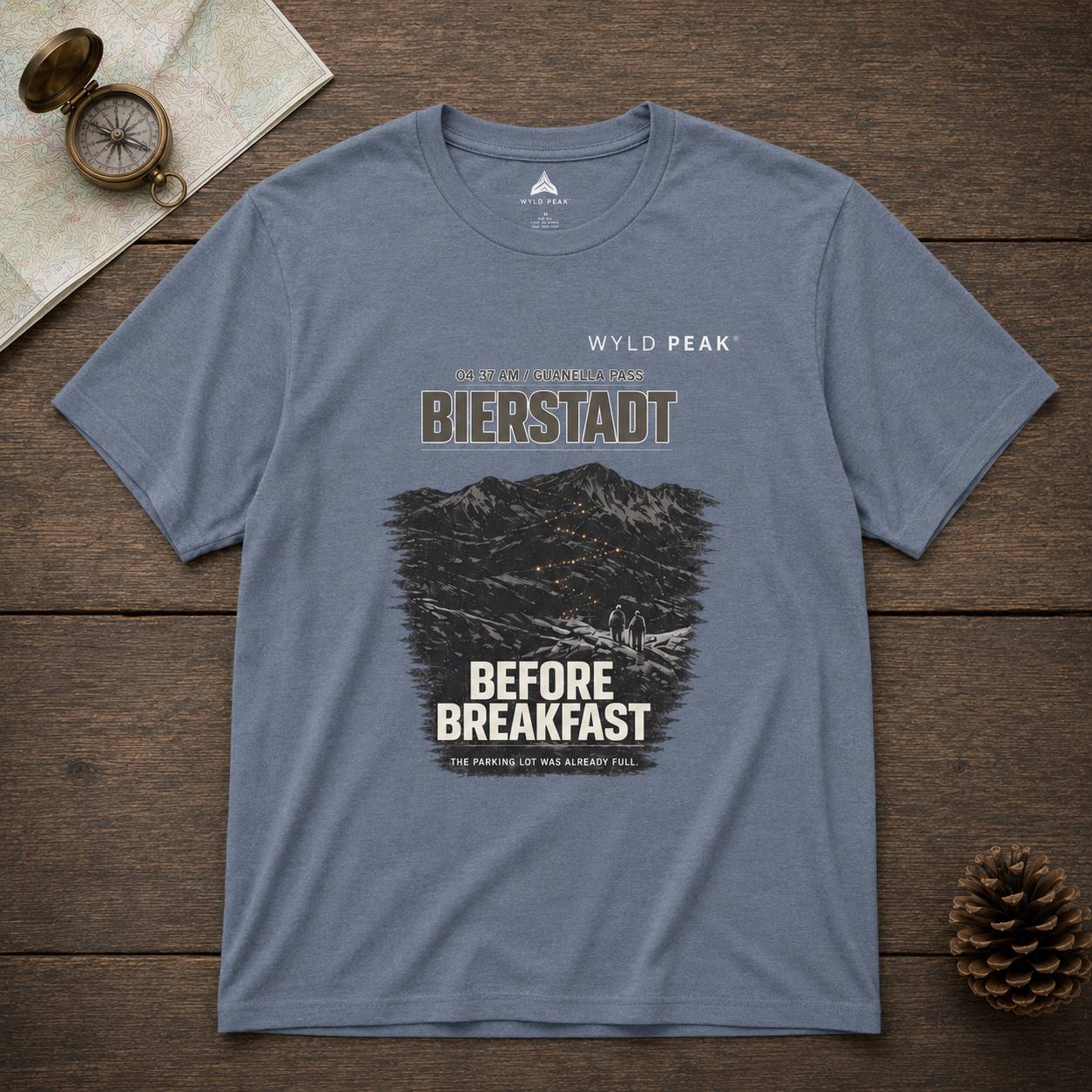 Blue t-shirt with graphic design on a wooden surface