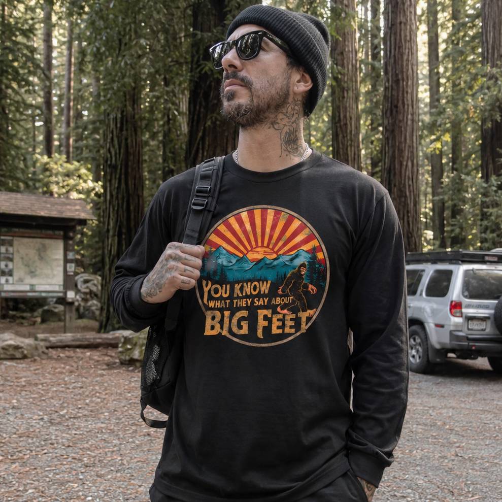 Man wearing a black sweatshirt with a graphic design in a forest setting