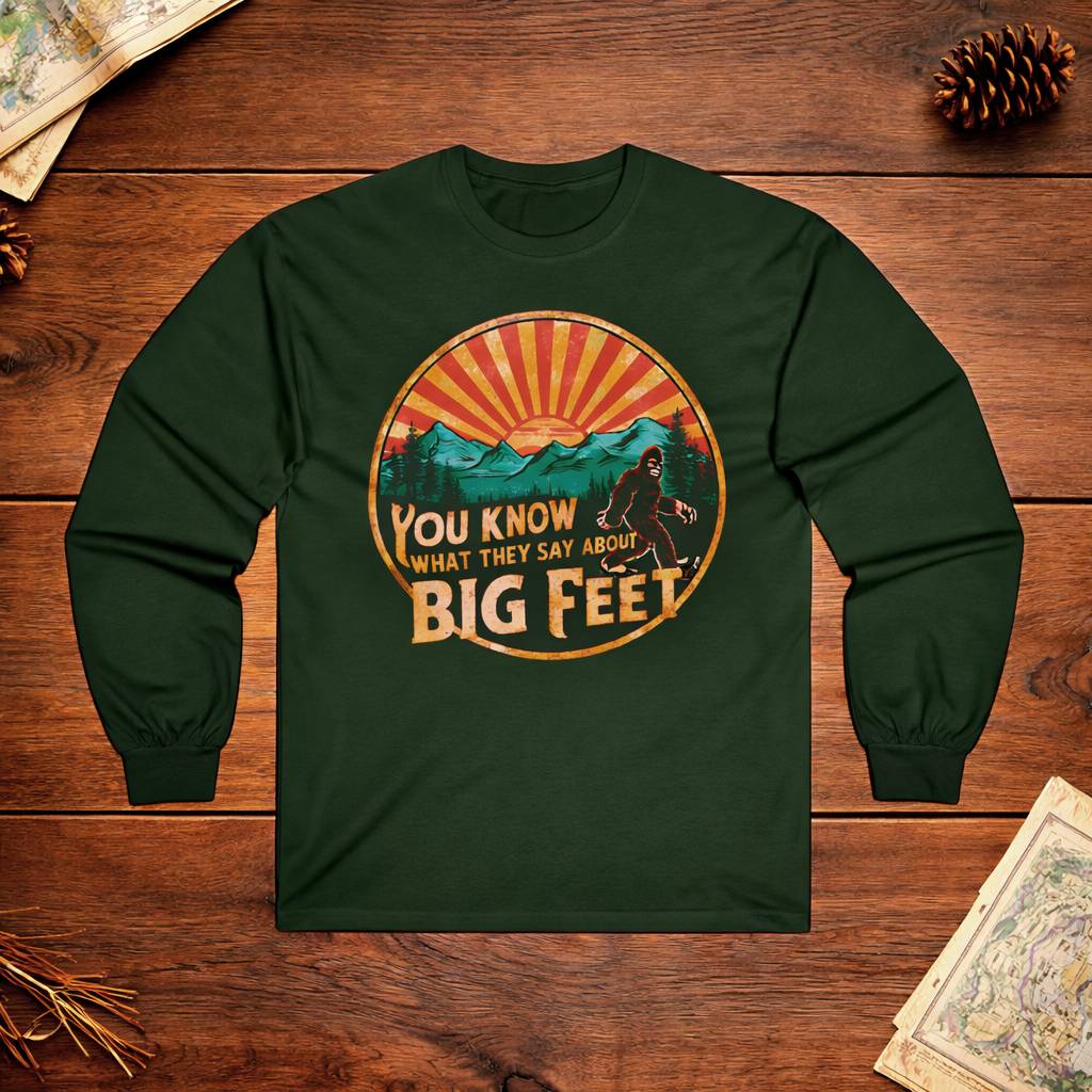 Green long-sleeve shirt with a graphic design on a wooden surface