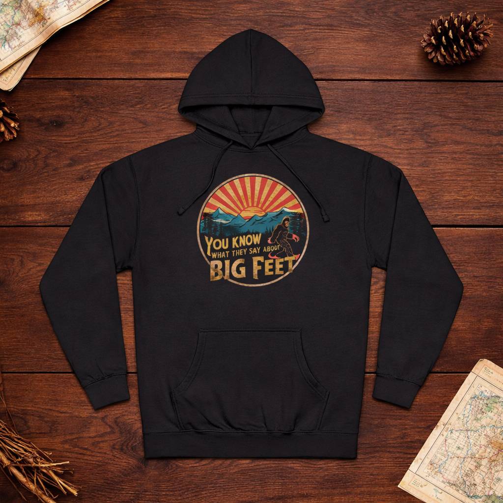Black hoodie with graphic design on a wooden surface