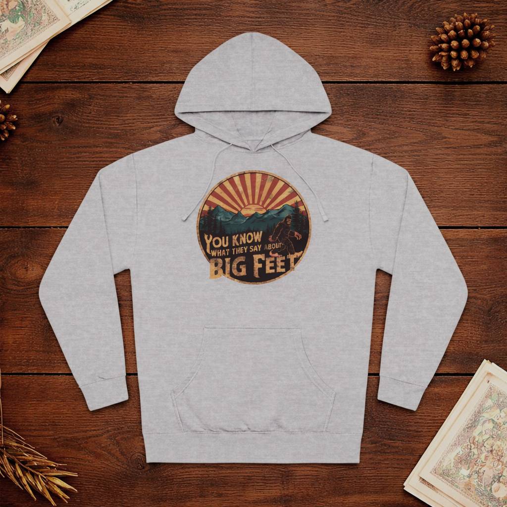 Gray hoodie with a graphic design on a wooden surface