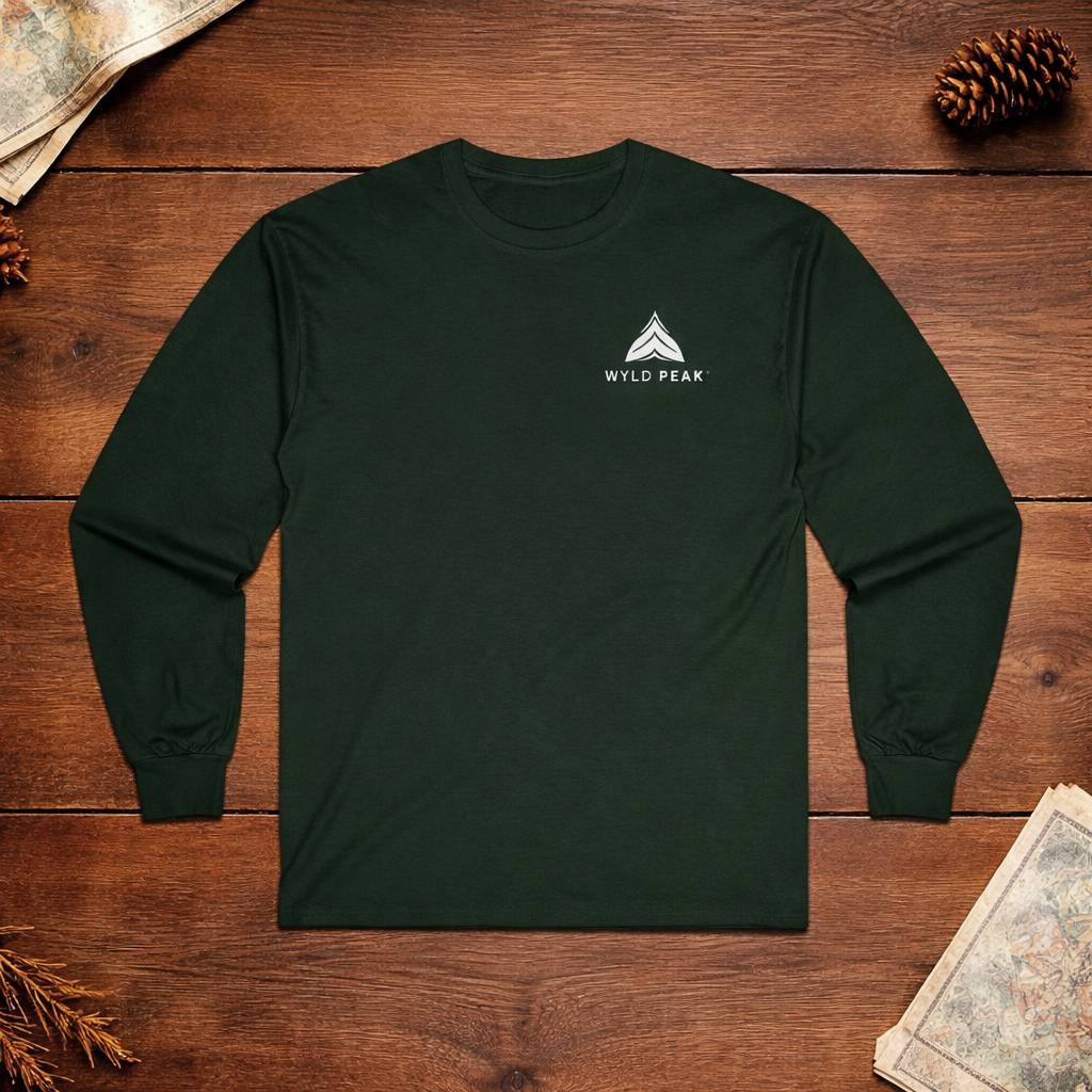 Dark green long-sleeve shirt with 'Wyld Peak' logo on a wooden surface