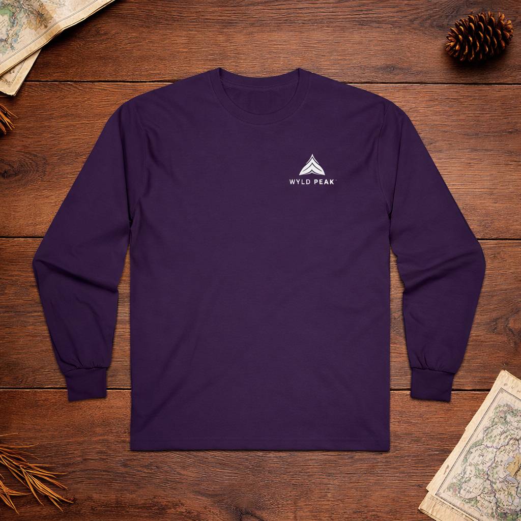 Purple long-sleeve shirt with a logo on a wooden surface