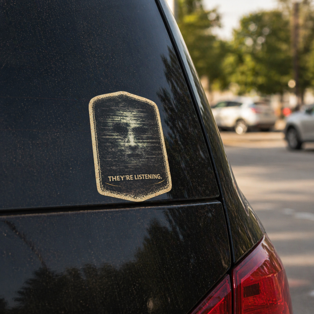 “They’re Listening” creepy sticker on car bumper, conspiracy style warning decal with static face design, bold and eerie automotive sticker
