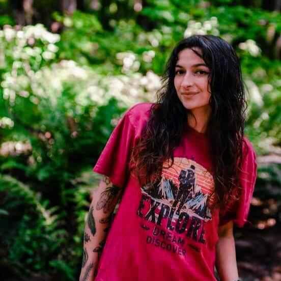 Emma in a maroon Wyld Peak Explorers eco tee in Oregon, alternate pose and angle.