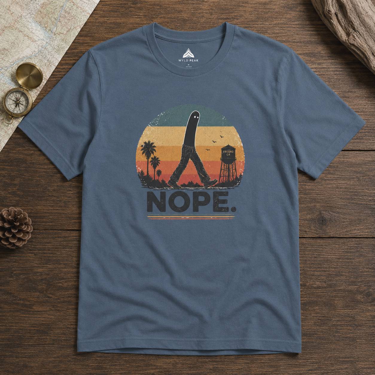 Blue t-shirt with a fresno nightcrawler graphic design on a wooden surface