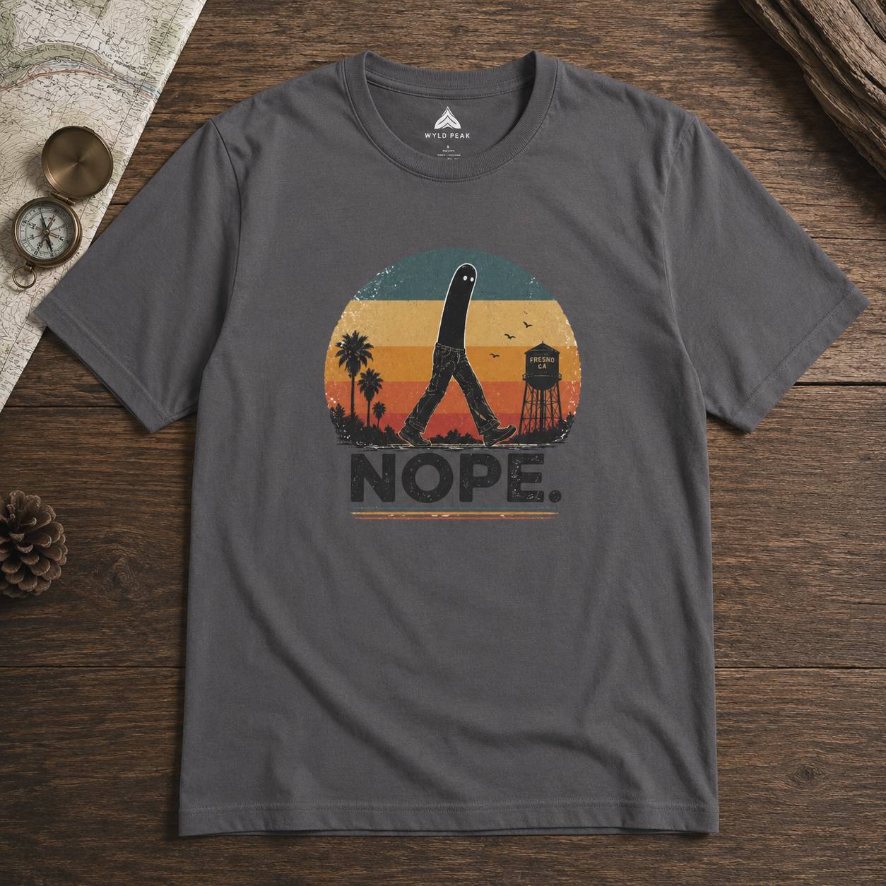 Gray t-shirt with a fresno nightcrawler graphic design on a wooden surface