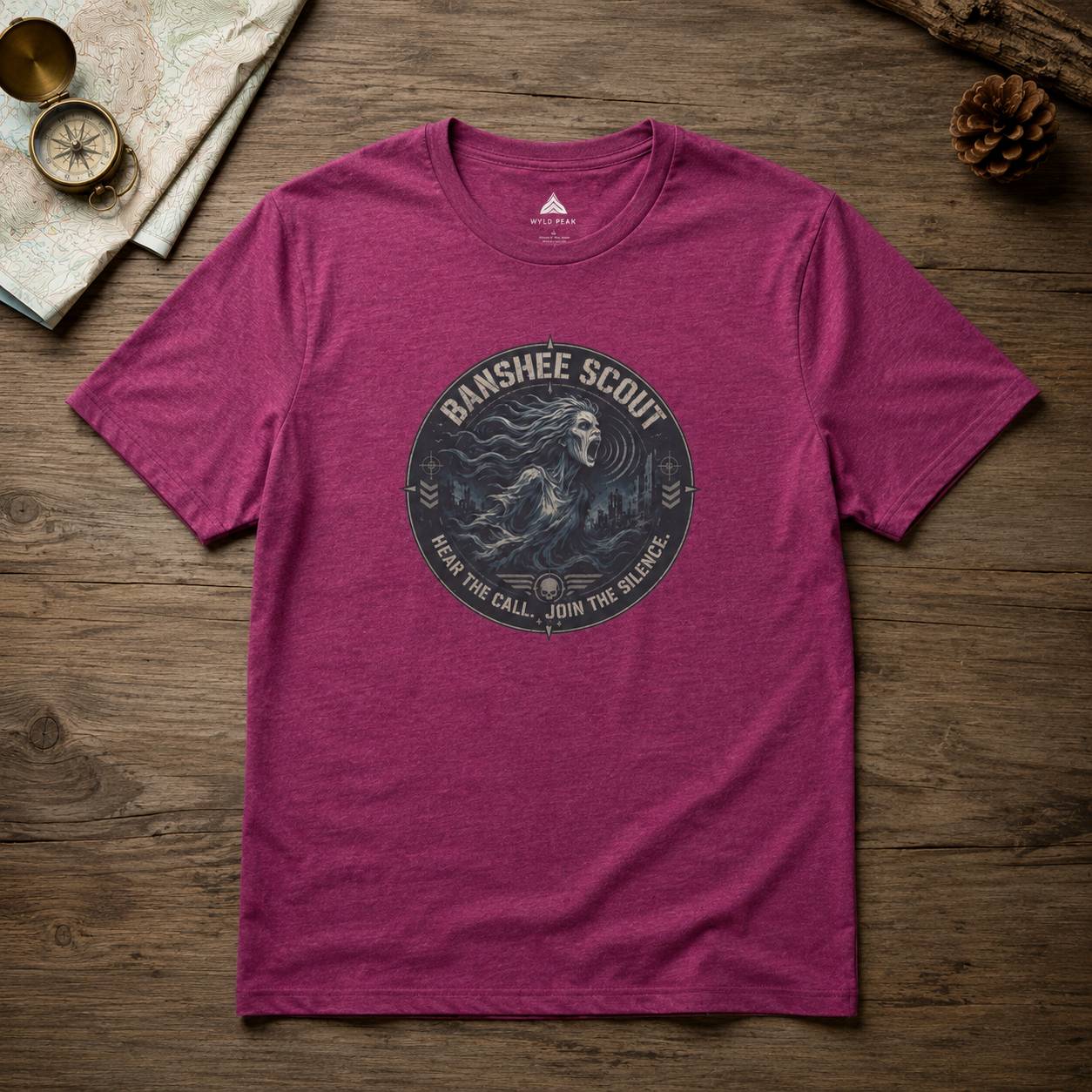 Purple t-shirt with 'Banshee Scout' graphic on a wooden surface