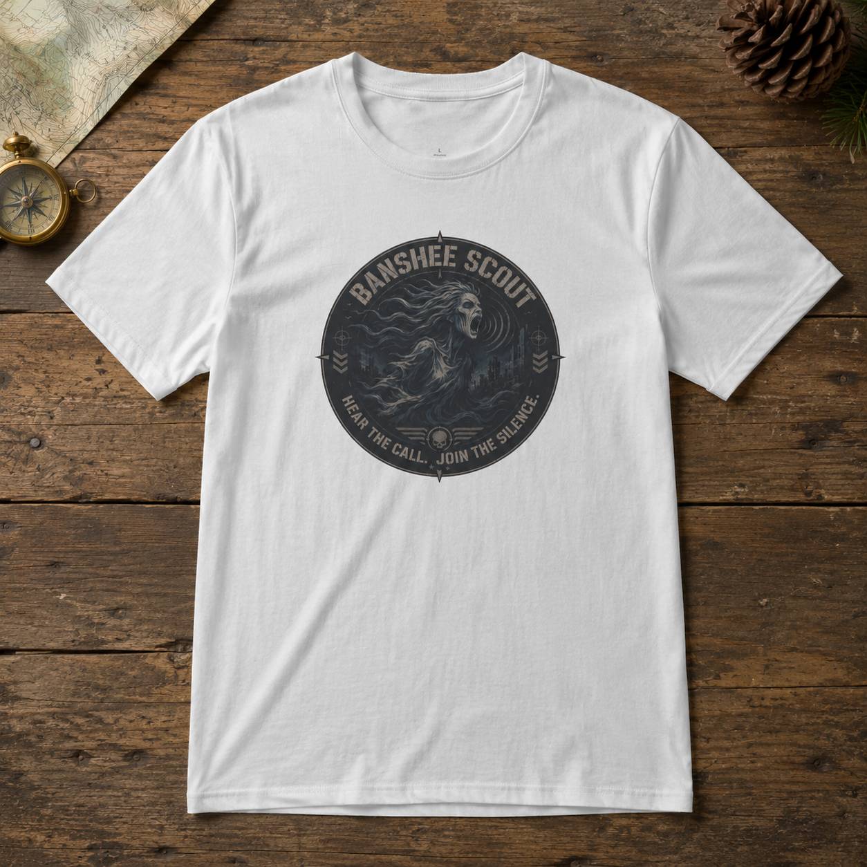 White t-shirt with 'Banshee Scout' graphic on a wooden surface