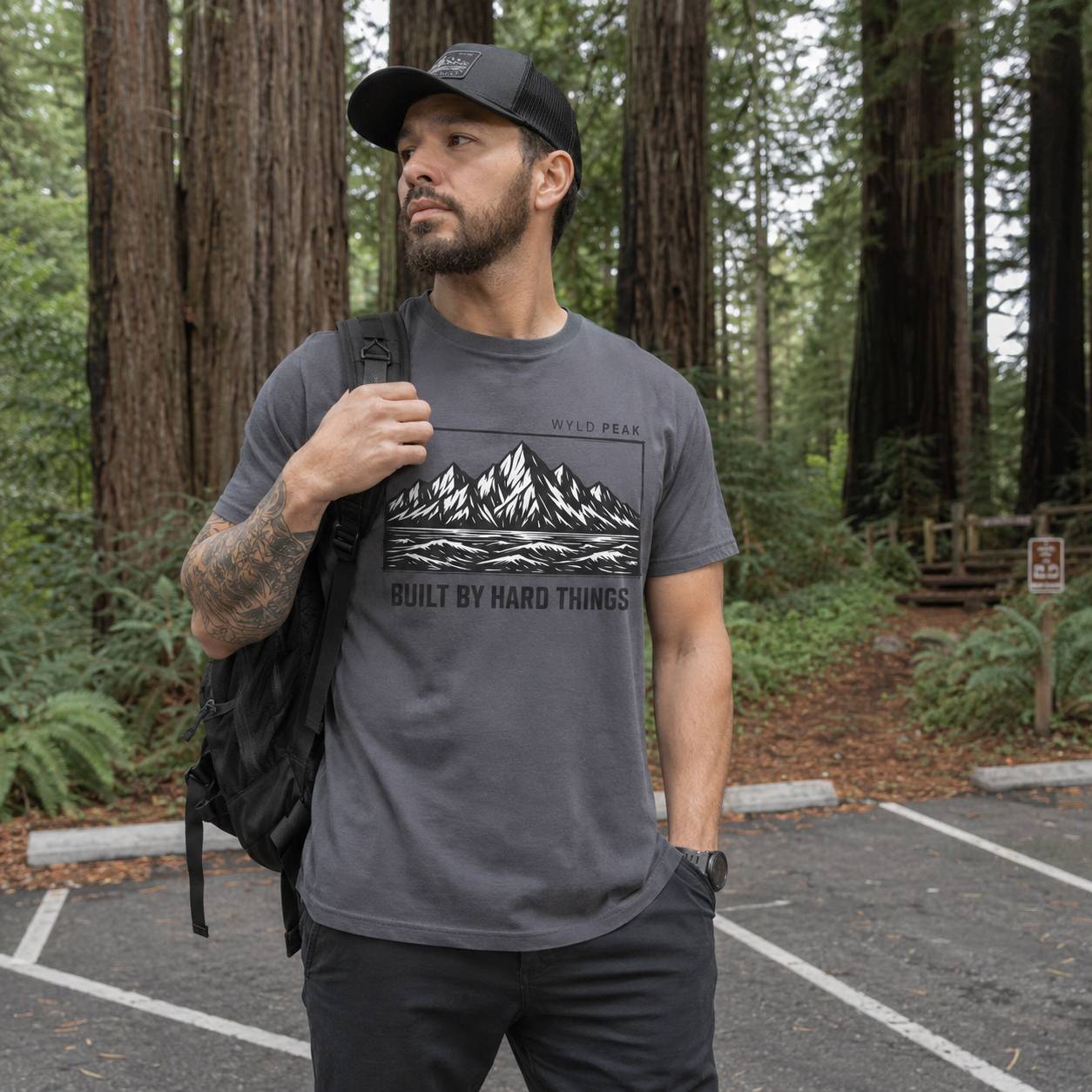 Man wearing a t-shirt with mountain design in a forest setting