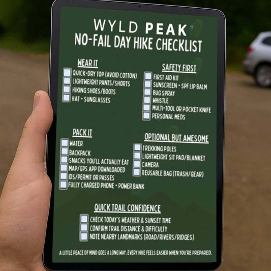 Hand holding a digital device displaying a hiking checklist with a forest background