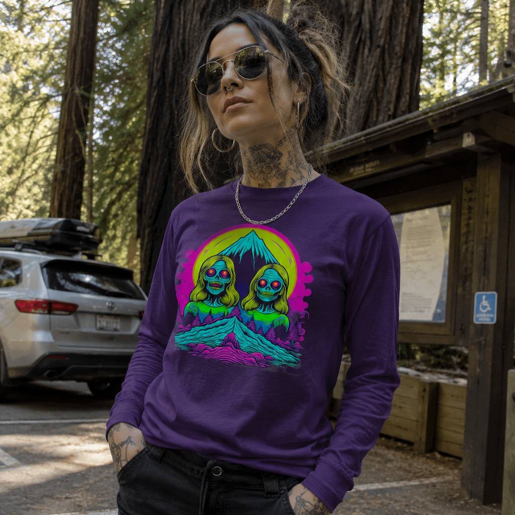 Person wearing a purple long-sleeve shirt with a colorful graphic in a forest setting