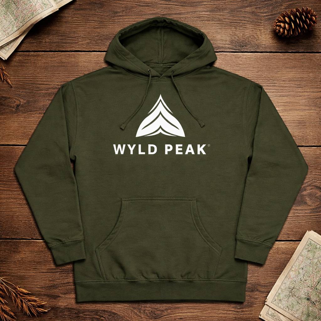Green hoodie with 'WYLD PEAK' logo on a wooden surface