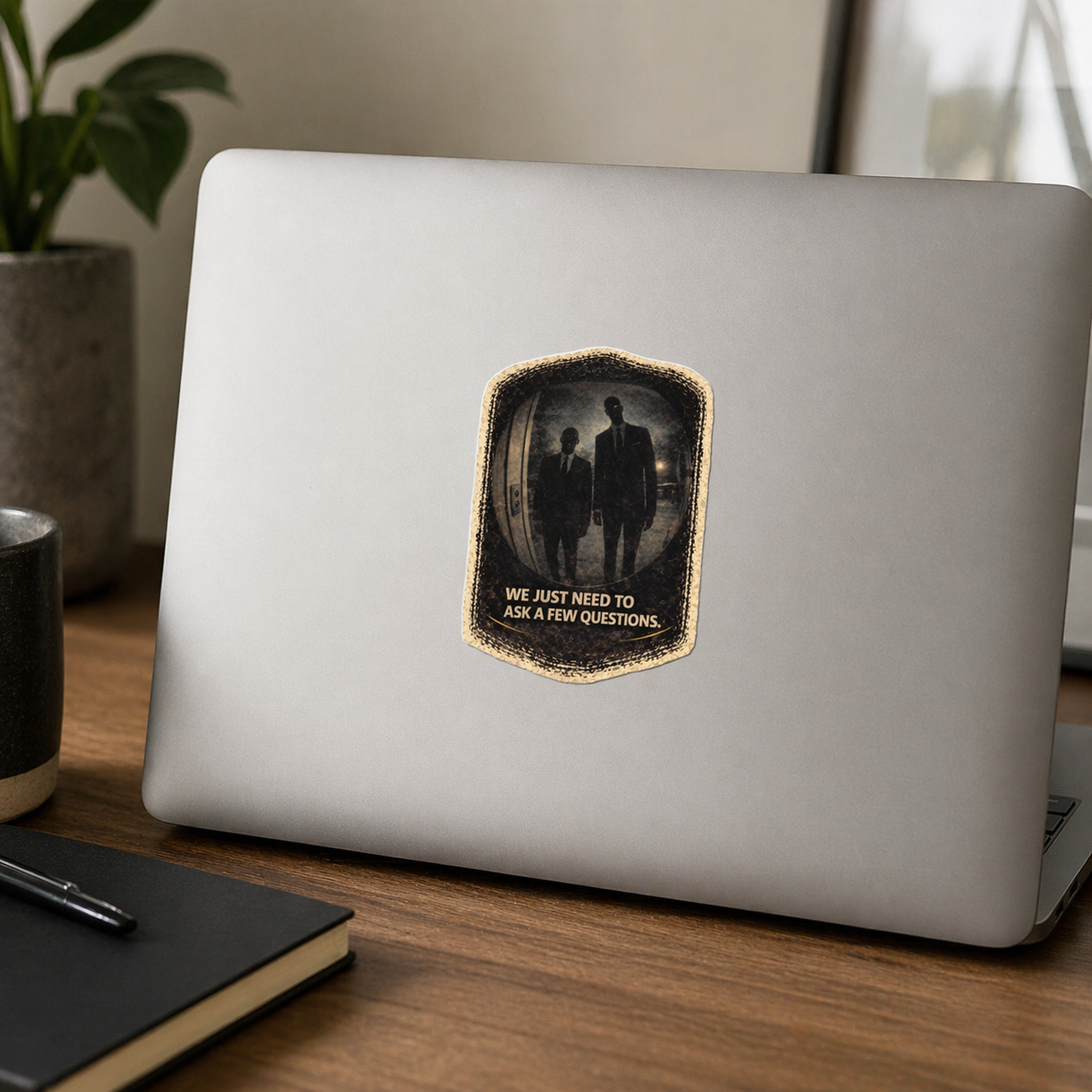 Laptop with a sticker on a wooden desk