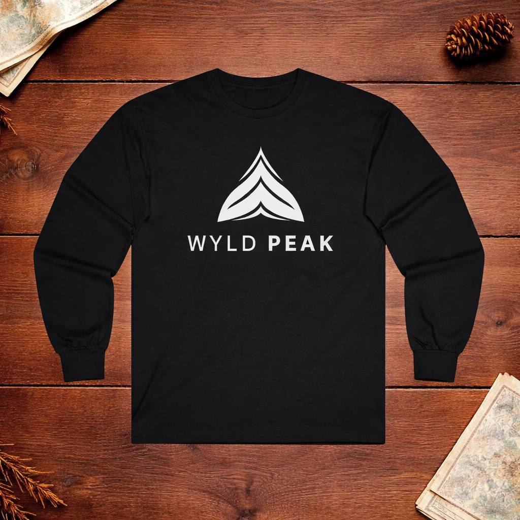 Black long-sleeve shirt with 'Wyld Peak' logo on a wooden surface