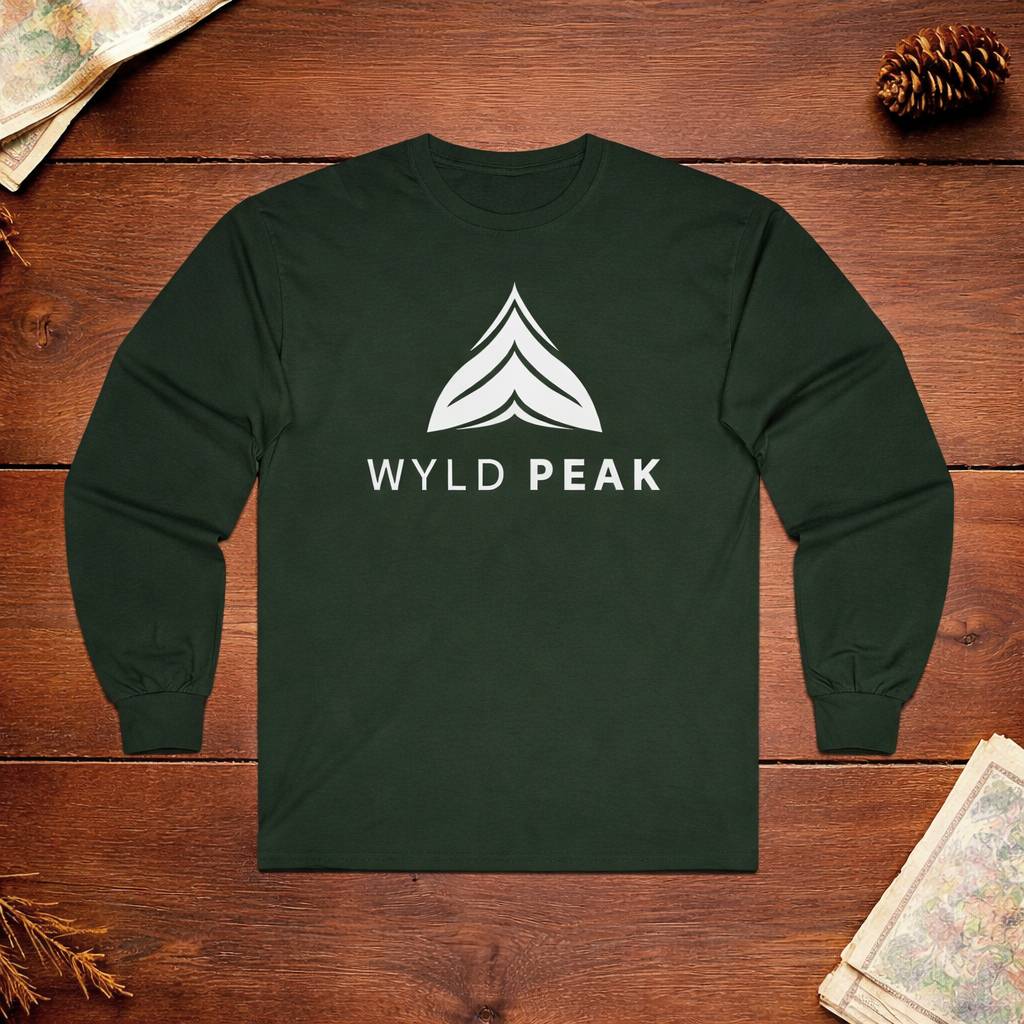 Dark green long-sleeve shirt with 'WYLD PEAK' logo on a wooden surface