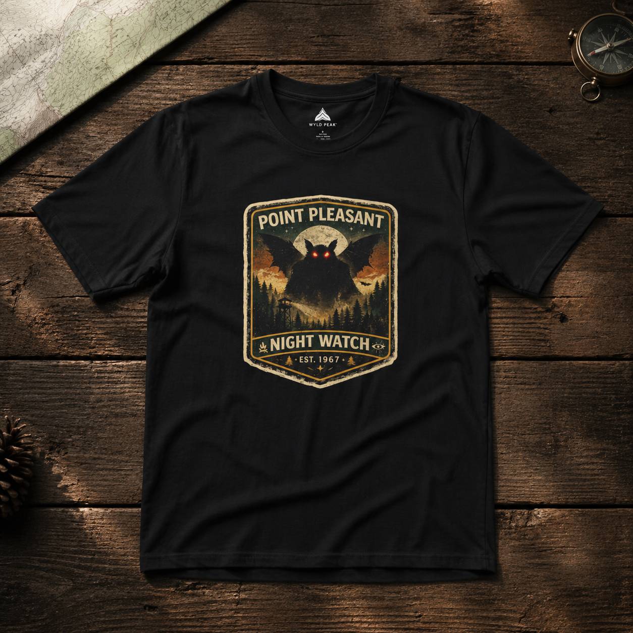 Black t-shirt with 'Point Pleasant Night Watch' graphic on a wooden surface