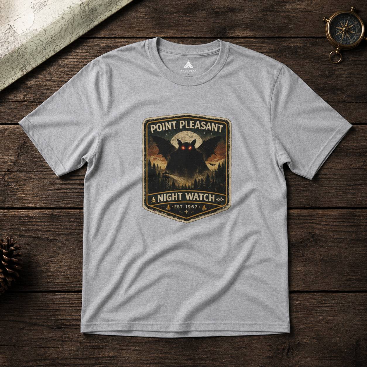 Gray t-shirt with 'Point Pleasant Night Watch' graphic on a wooden surface