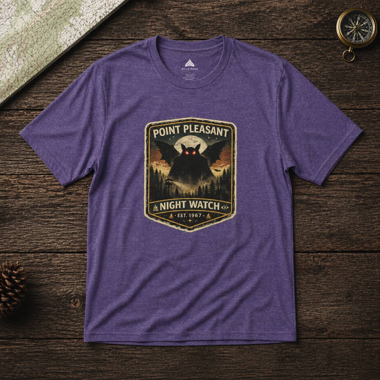 Purple t-shirt with 'Point Pleasant Night Watch' graphic on a wooden surface