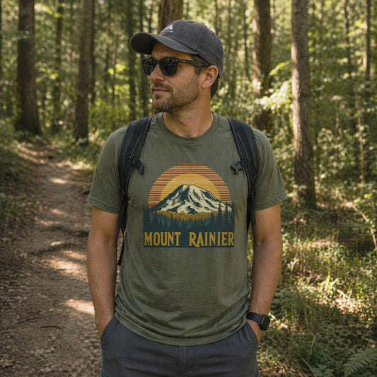 Man wearing a 'Mount Rainier' t-shirt in a forest setting