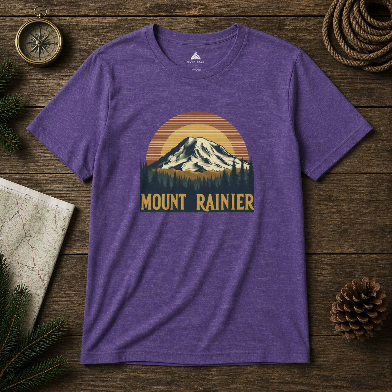 Purple t-shirt with Mount Rainier graphic on a wooden surface