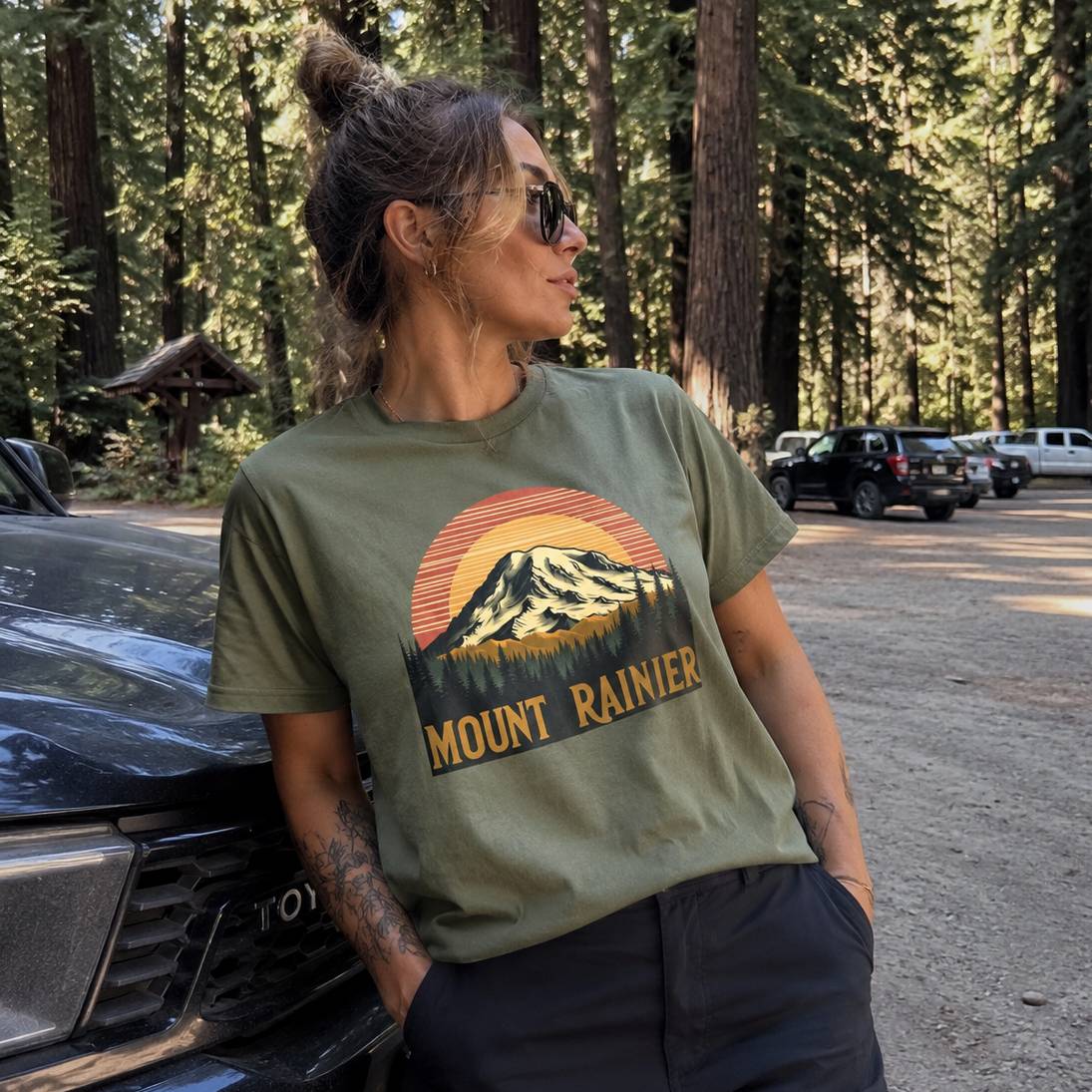 Person wearing a Mount Rainier t-shirt in a forest setting
