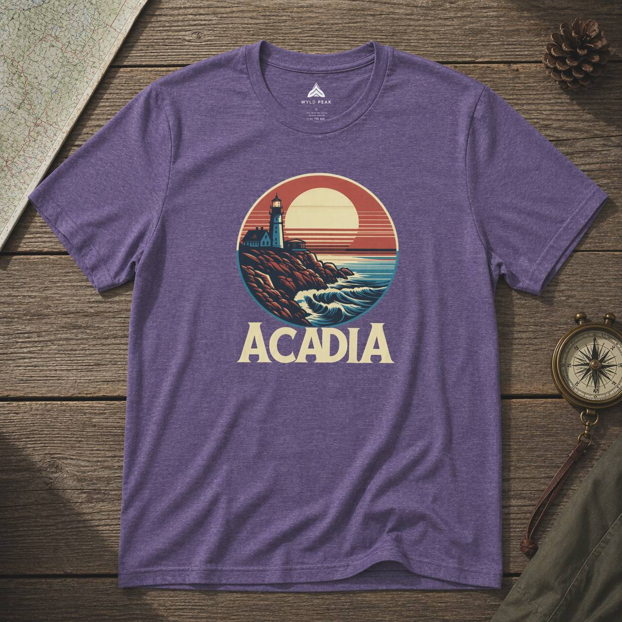 Purple t-shirt with Acadia national park graphic on a wooden surface