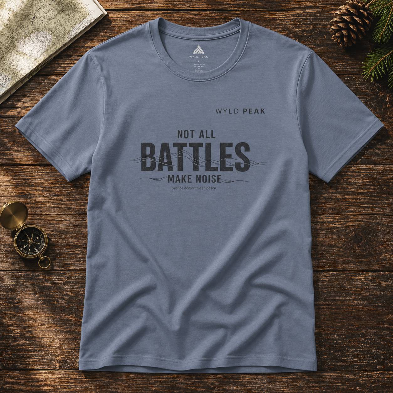 Blue t-shirt with text on a wooden surface