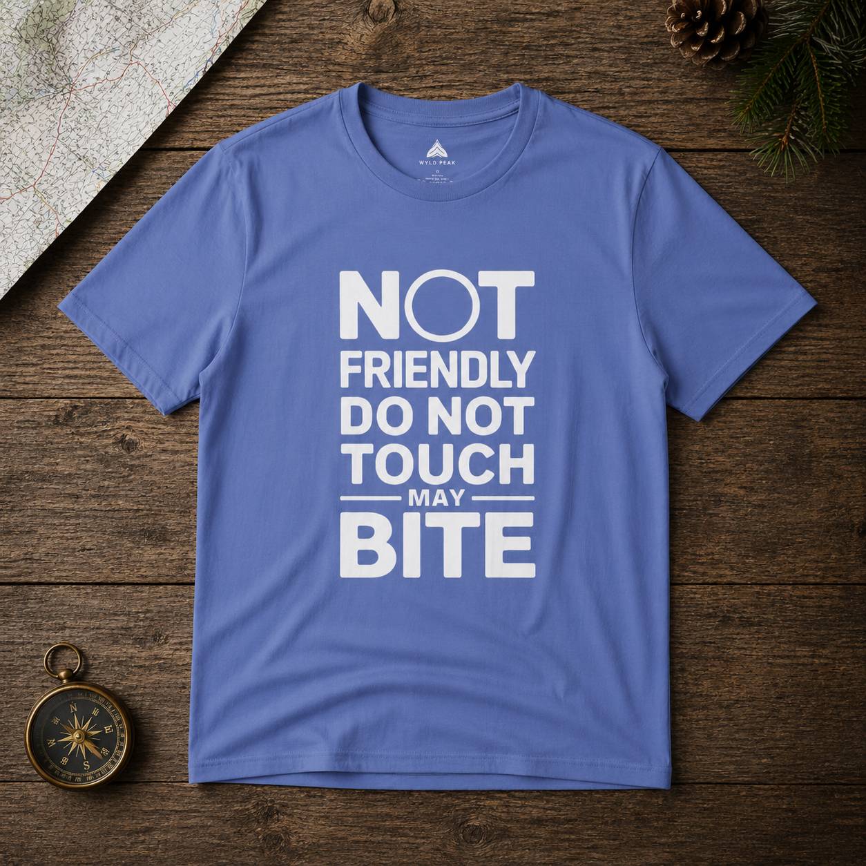 Blue t-shirt with white text on a wooden surface