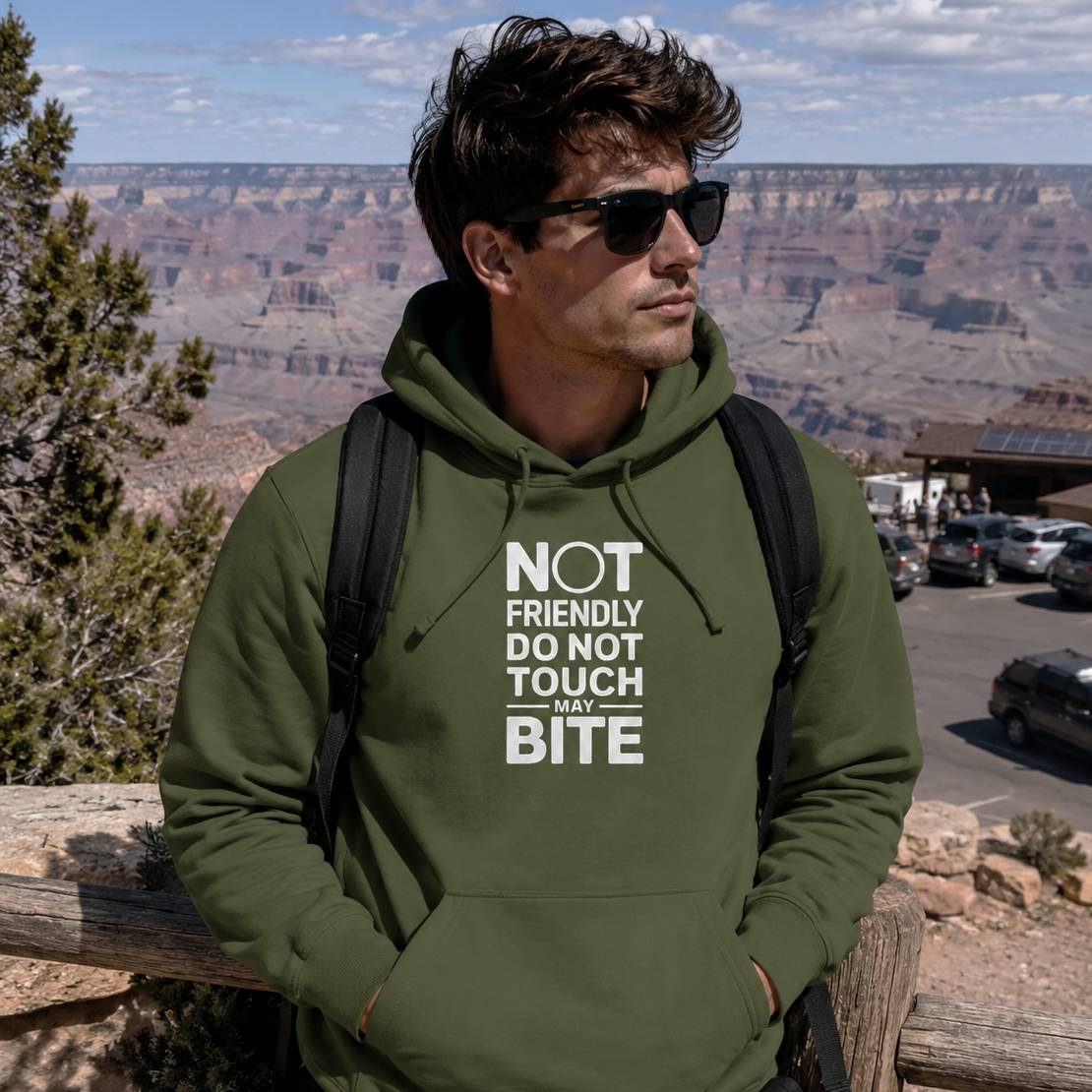 Man wearing a green hoodie with text at the Grand Canyon