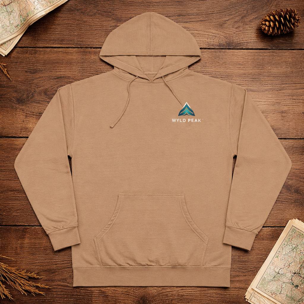 Brown hoodie with a logo on a wooden surface with nature-themed items.