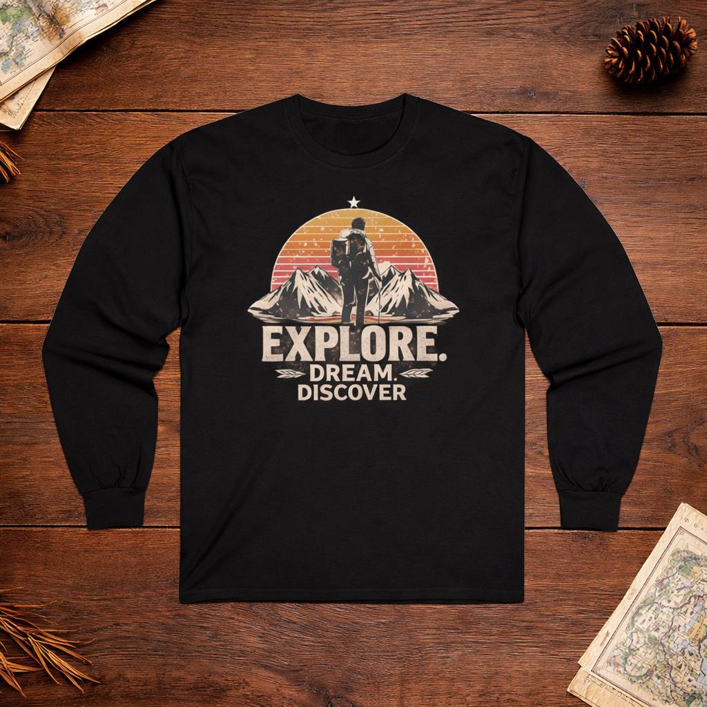Black long-sleeve shirt with 'Explore. Dream. Discover.' graphic on a wooden surface.