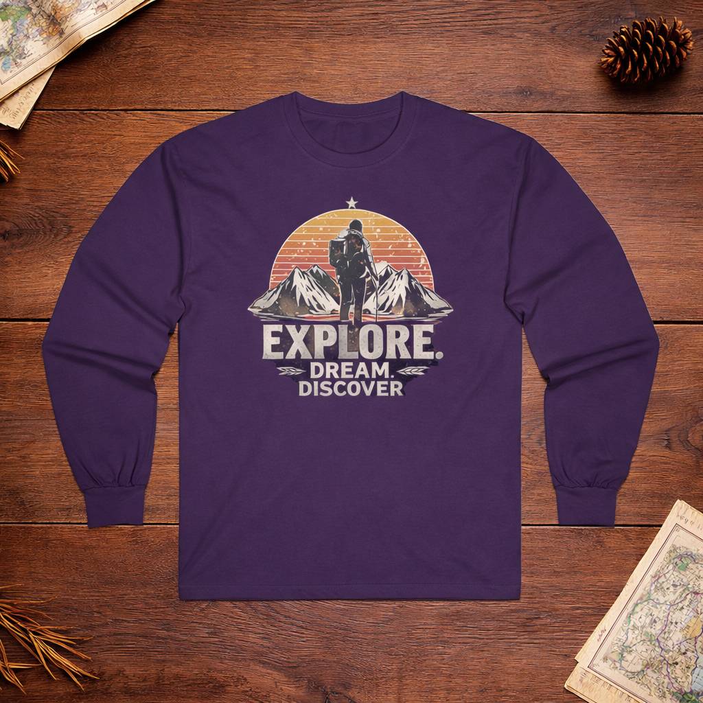 Purple long-sleeve shirt with 'Explore Dream Discover' graphic on a wooden surface