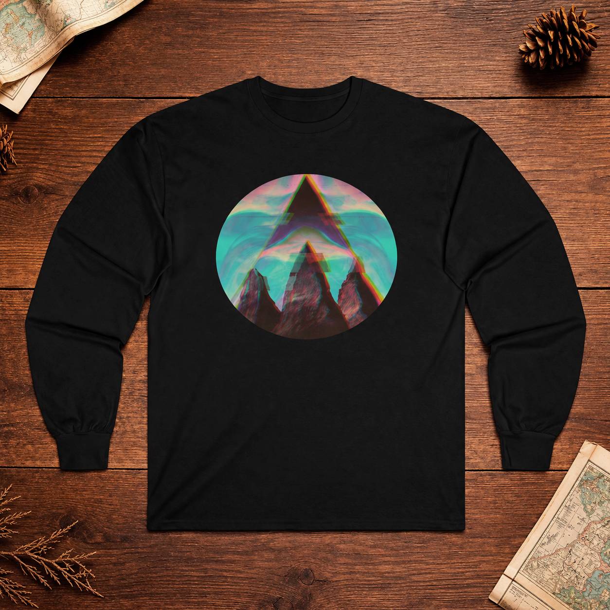 Black long-sleeve shirt with a colorful mountain graphic on a wooden surface.