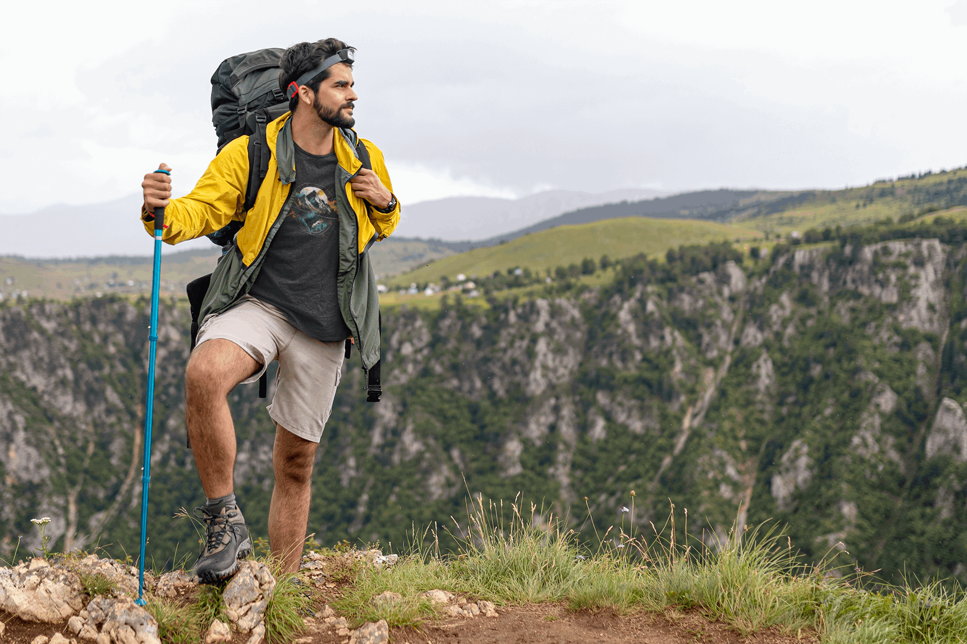 Man hiking in Wyld Peak Peak black organic tee on scenic American trail