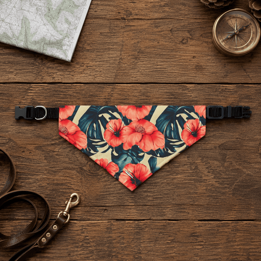 Floral patterned dog bandana on a wooden surface with a leash and compass.