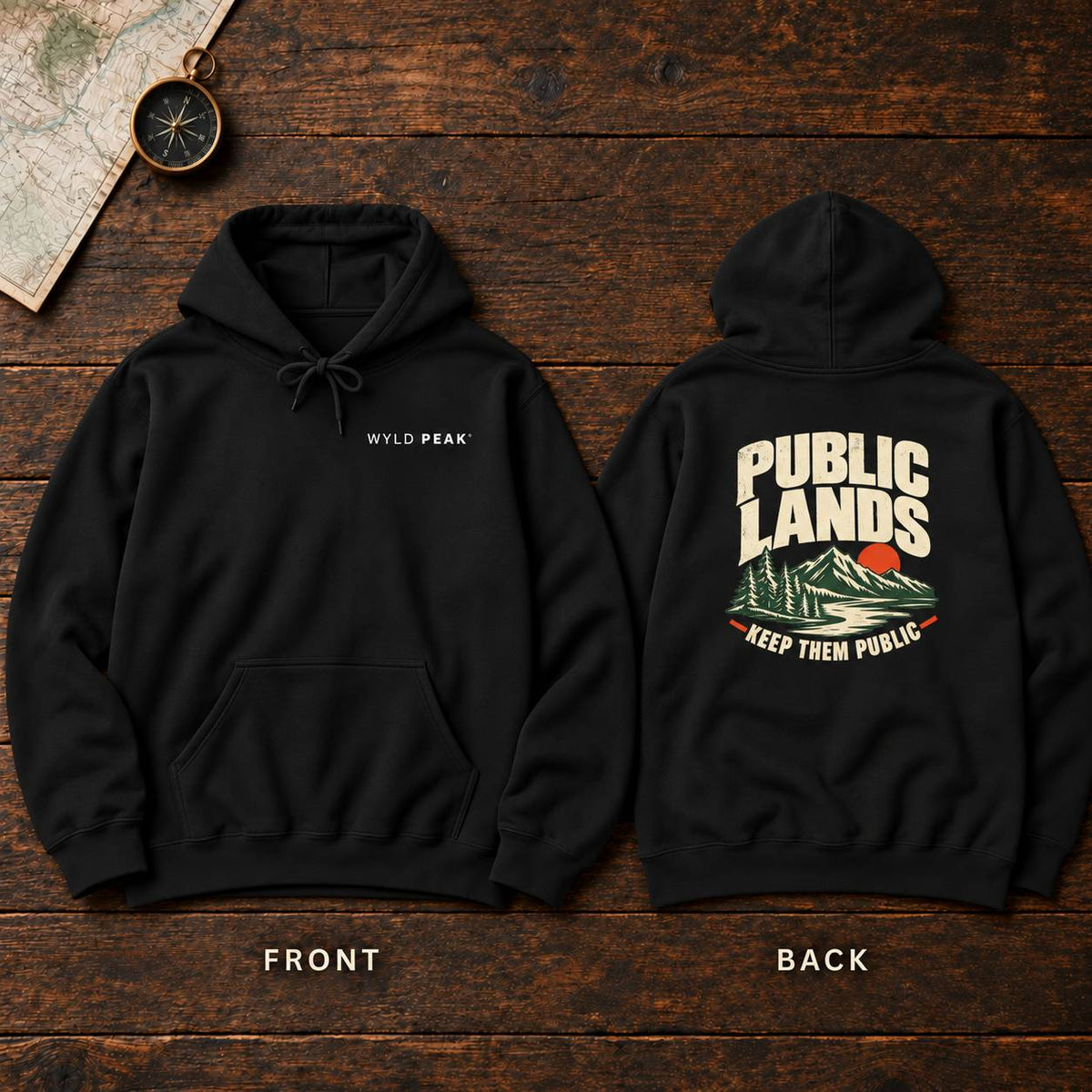 Black pullover hoodie shown from both front and back on a rustic dark wood background. The front has small white 'WYLD PEAK' text on the chest, and the back has a large cream, green, and red mountain graphic with the words 'PUBLIC LANDS' and 'KEEP THEM PUBLIC.