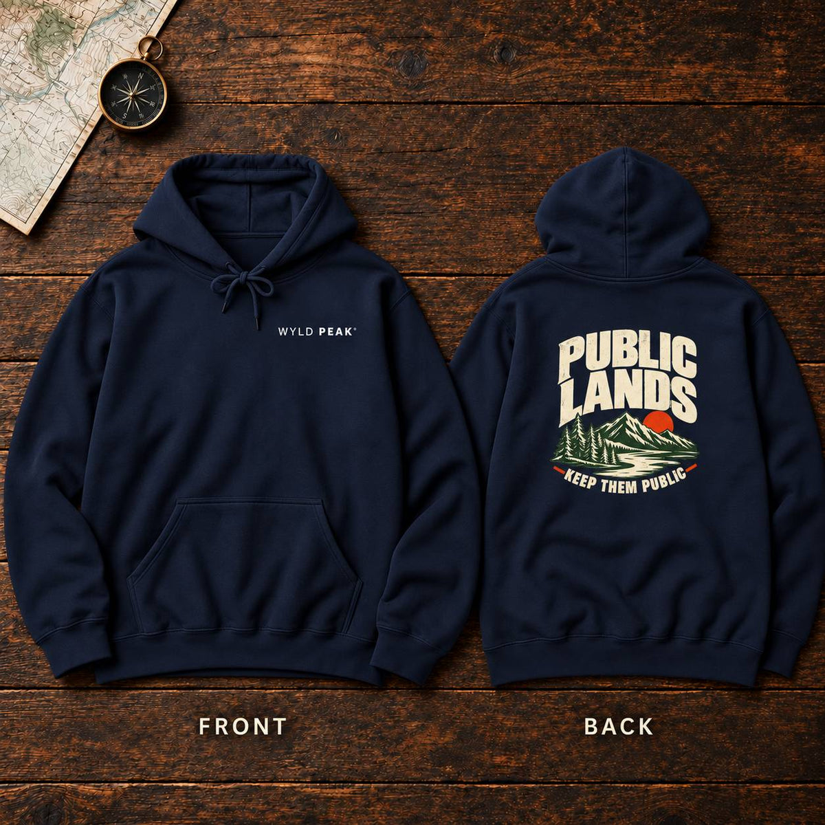 A navy pullover hoodie shown from both front and back on a rustic dark wood background. The front has a small white 'WYLD PEAK' logo on the left chest, and the back has a large graphic with 'PUBLIC LANDS' in white over a mountain scene with a red sun and the phrase 'KEEP THEM PUBLIC' in red.