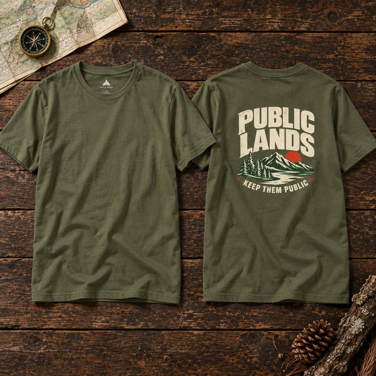 Two olive green t-shirts displayed side-by-side on a rustic dark wood background, showing both the front and back views. The front is plain, while the back features a graphic with the text 'PUBLIC LANDS' in cream, a green mountain, a red sun, and the phrase 'KEEP THEM PUBLIC' in red.