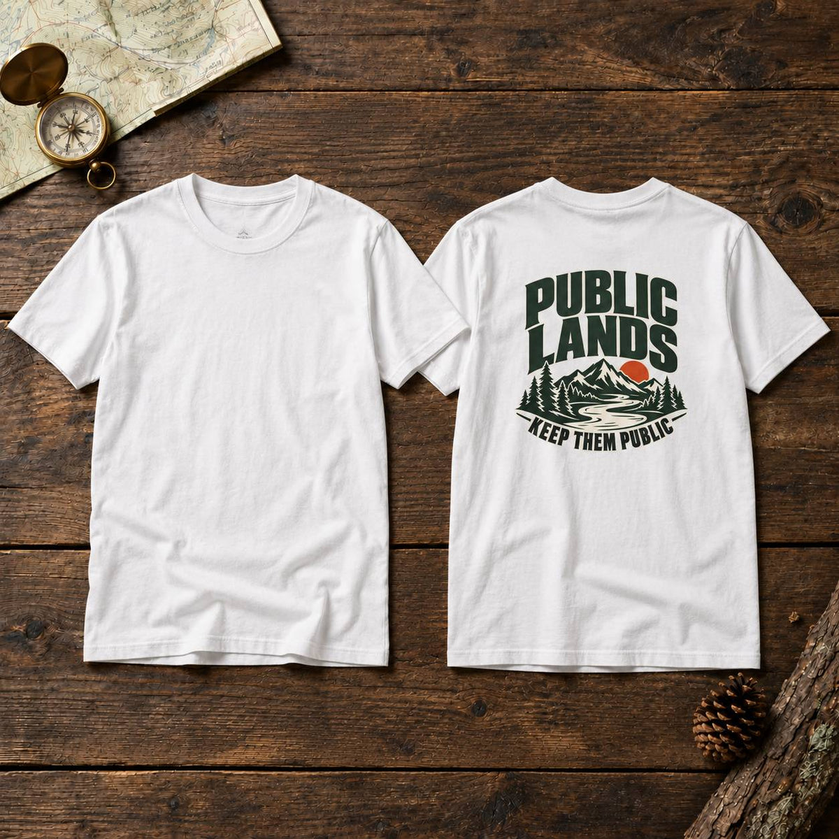 Two white short-sleeve T-shirts shown flat on a rustic wooden surface, with the front view on the left and back view on the right. The back has a large dark green and orange graphic reading “PUBLIC LANDS KEEP THEM PUBLIC” with a mountain and trees illustration.