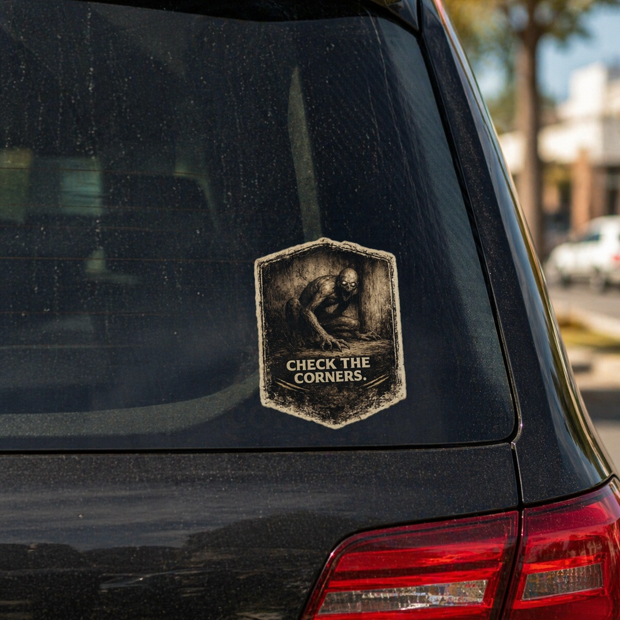 Sticker on a car's rear window with text 'Check the Corners' in an urban setting.