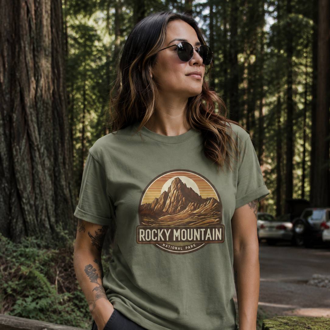Woman wearing a green t-shirt with Rocky Mountain National Park graphic in a forest setting